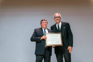 two men holding a certificate