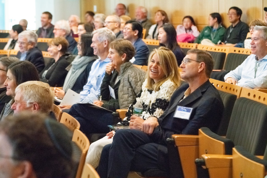 Audience members watching presentations