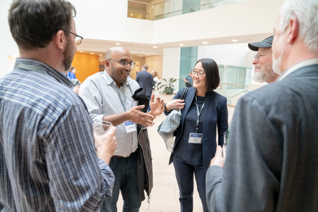 several people stand around chatting