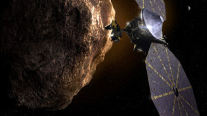 Image of Lucy spacecraft next to asteroid