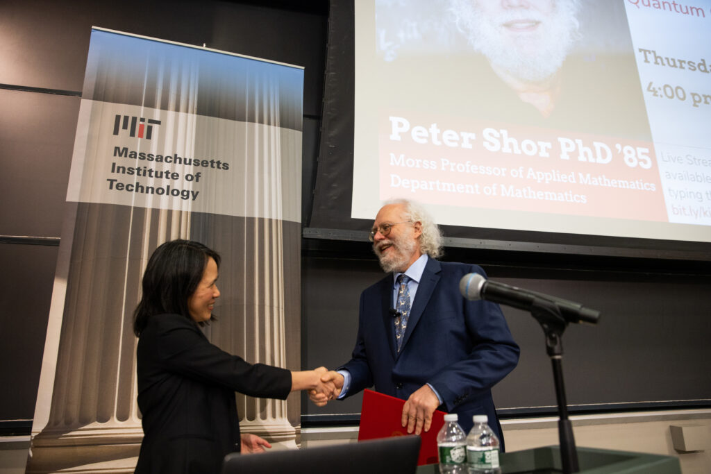 Lily Tsai and Peter Shor shake hands